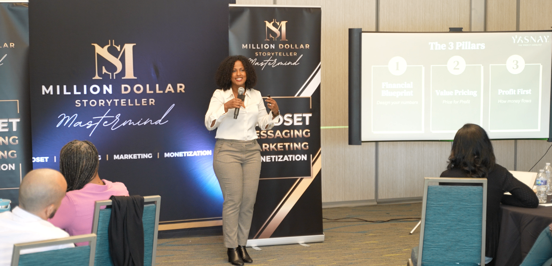 Yasnay Montalvo speaking at the Million Dollar Storyteller Mastermind — presenting The 3 Pillars framework for financial clarity, value pricing, and profit optimization